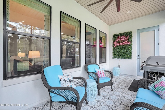 view of patio with area for grilling, ceiling fan, and a porch