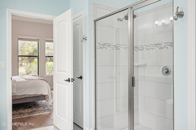 bathroom featuring walk in shower and hardwood / wood-style flooring