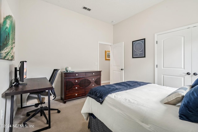 carpeted bedroom featuring a closet