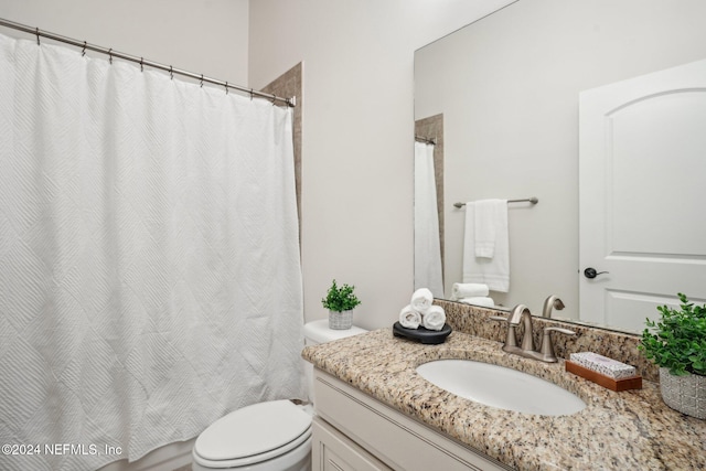 bathroom featuring vanity, toilet, and curtained shower