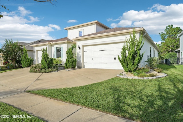 view of front of property with a garage and a front lawn