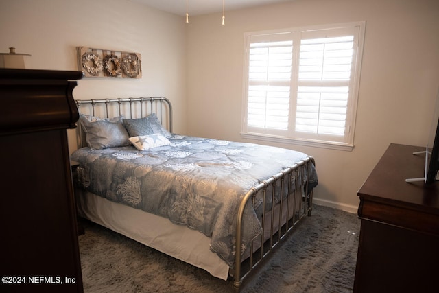 bedroom featuring dark colored carpet