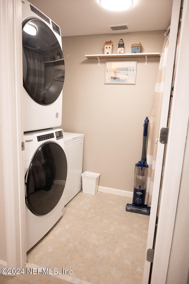 laundry room featuring stacked washer and clothes dryer