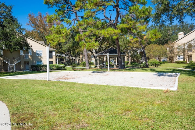 surrounding community featuring a yard and volleyball court