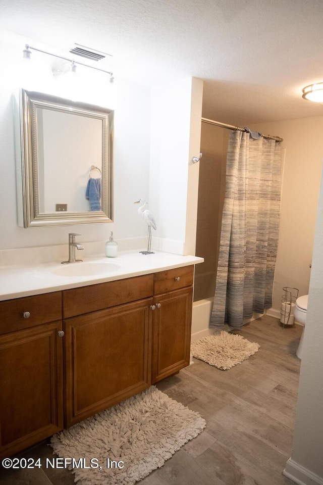 21 Arbor Club Dr Unit 101, Ponte Vedra Beach, FL 32082 - bathroom with visible vents, shower / bath combo, wood finished floors, vanity, and toilet