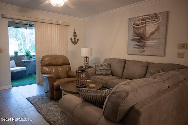 living room with crown molding, light hardwood / wood-style floors, and ceiling fan