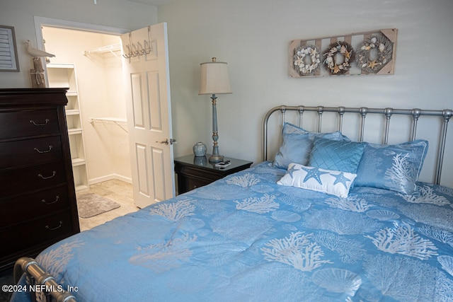 bedroom with a spacious closet and a closet