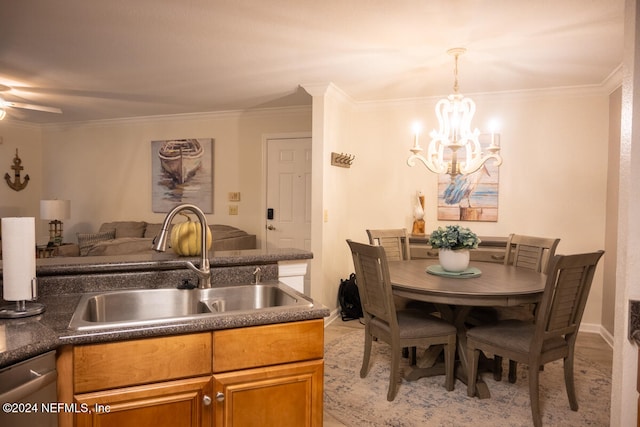 kitchen with dishwasher, hanging light fixtures, sink, crown molding, and ceiling fan with notable chandelier