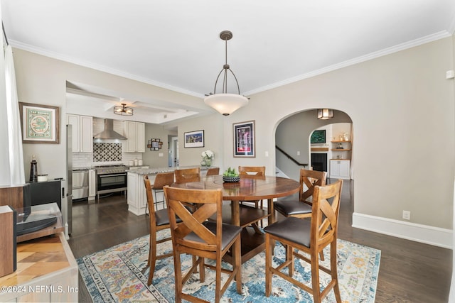 dining area with dark wood-type flooring and crown molding