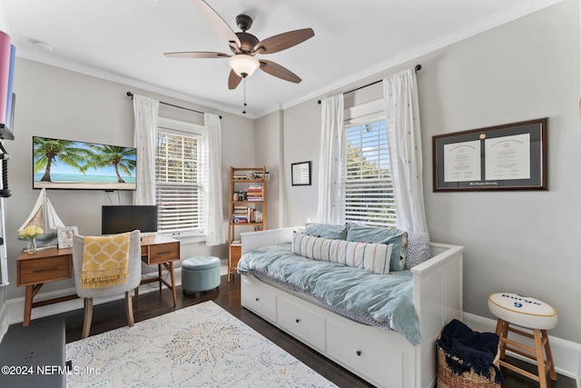 bedroom featuring dark wood-type flooring, ceiling fan, and multiple windows