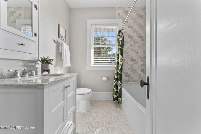 full bathroom featuring toilet, vanity, tile patterned flooring, and shower / bathtub combination with curtain