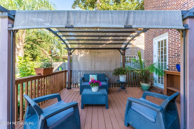 wooden deck featuring a pergola and an outdoor hangout area