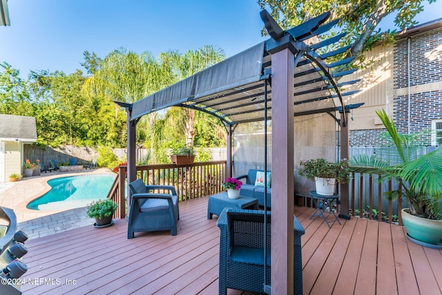 deck featuring a fenced in pool and a pergola