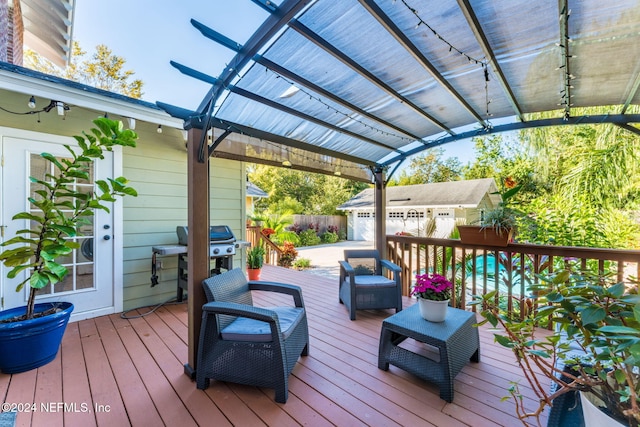 deck featuring a grill and a pergola