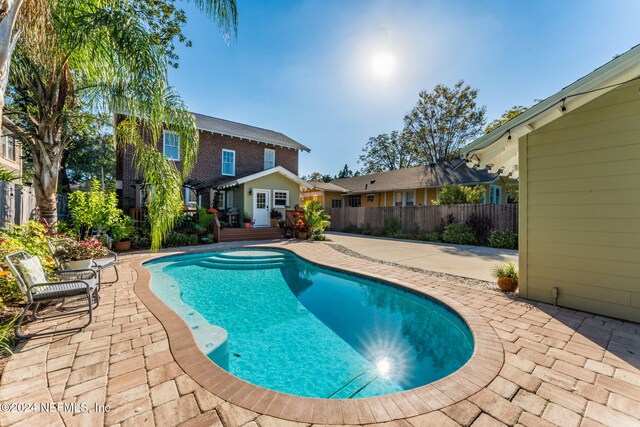 view of swimming pool featuring a patio area