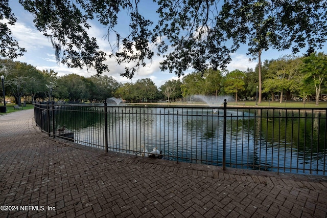 view of swimming pool with a water view