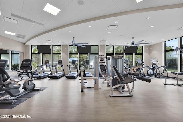 gym with expansive windows and ceiling fan