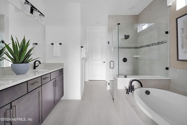 bathroom featuring vanity, independent shower and bath, and tile patterned floors