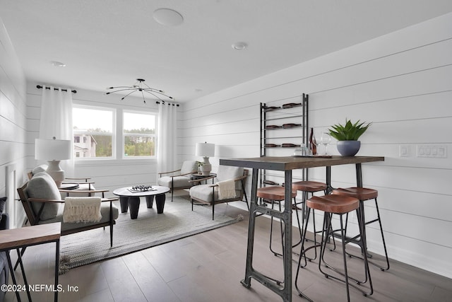 interior space with hardwood / wood-style floors and wooden walls