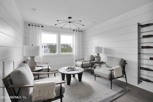 living room featuring hardwood / wood-style floors and wood walls