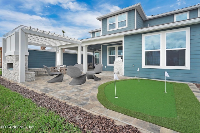 back of property with an outdoor living space, a patio, and a pergola