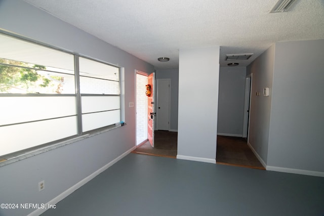 spare room with a textured ceiling