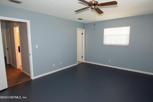 spare room featuring ceiling fan and a textured ceiling