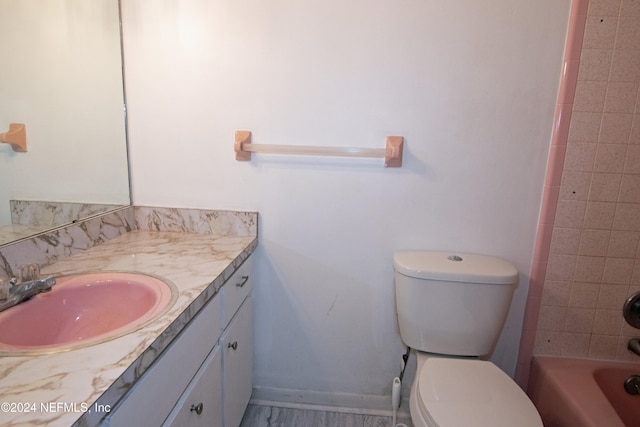 full bathroom featuring vanity, toilet, and tiled shower / bath combo