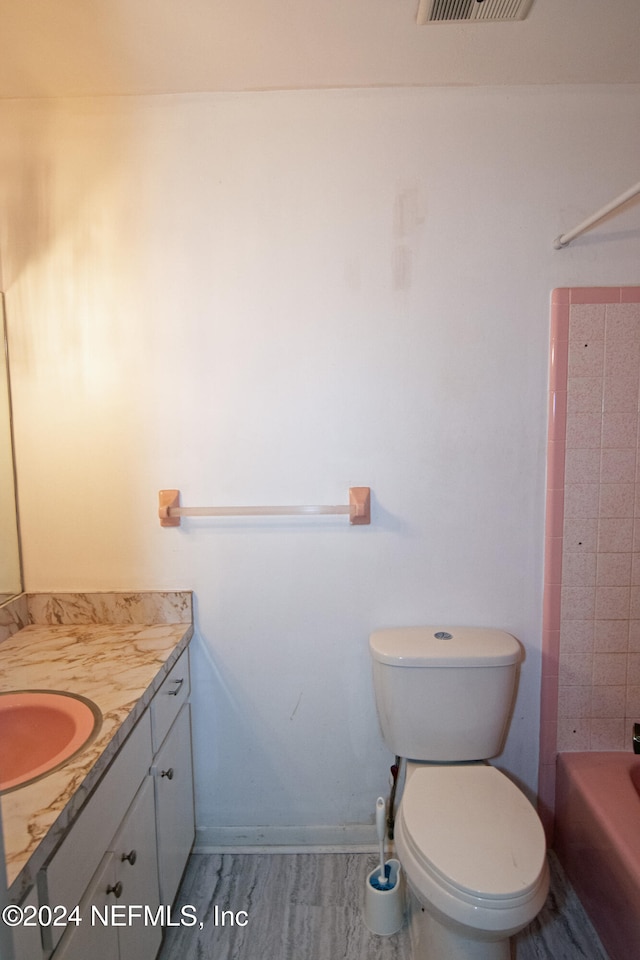 full bathroom featuring vanity, toilet, and bathing tub / shower combination