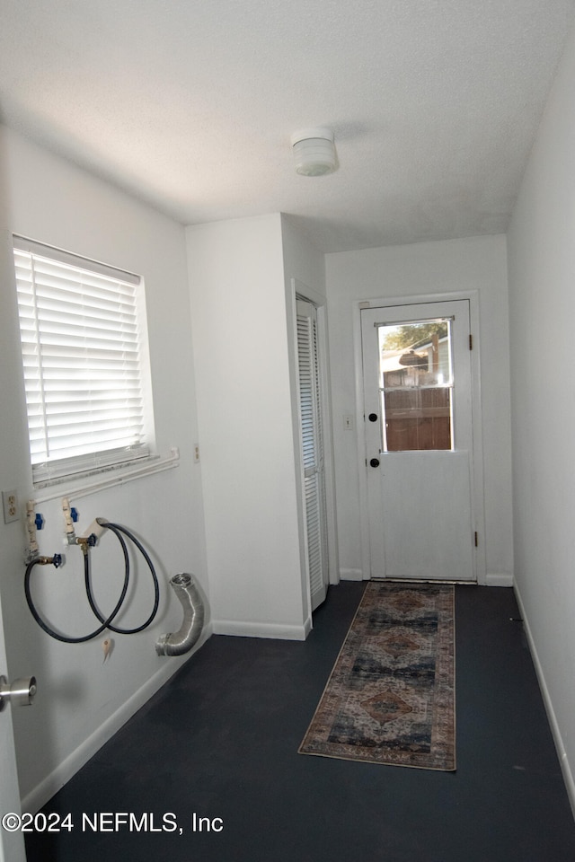 doorway featuring dark carpet