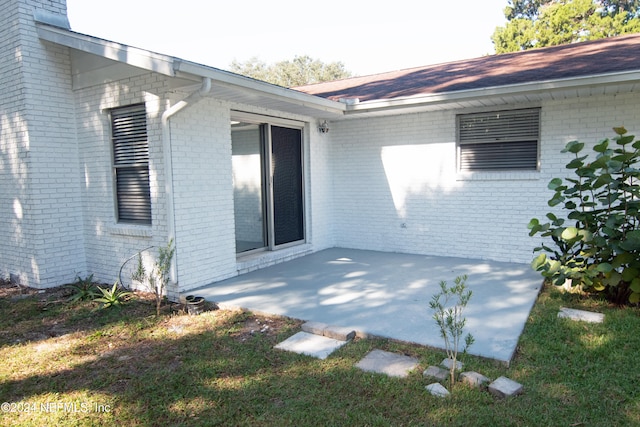 exterior space with a lawn and a patio area