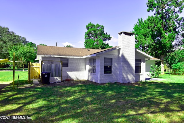 back of property featuring a yard