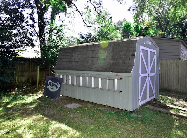 view of outbuilding featuring a lawn