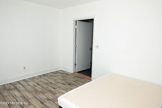 unfurnished bedroom with hardwood / wood-style flooring