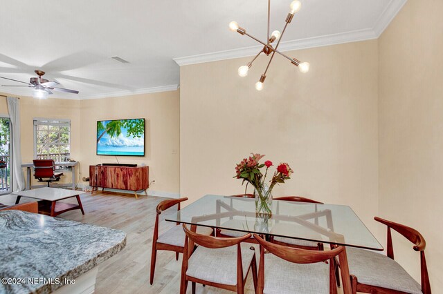 dining room featuring ornamental molding, light wood-type flooring, and ceiling fan with notable chandelier