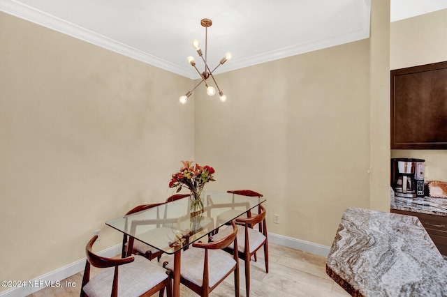 dining area featuring baseboards, ornamental molding, and an inviting chandelier