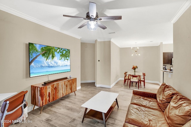 living room featuring crown molding, light hardwood / wood-style flooring, and ceiling fan with notable chandelier