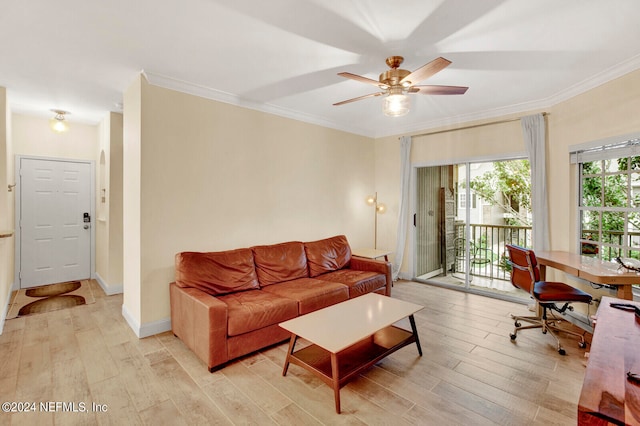 living area with ornamental molding, ceiling fan, light wood finished floors, and baseboards