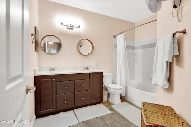 full bathroom featuring toilet, shower / tub combo with curtain, vanity, and wood-type flooring