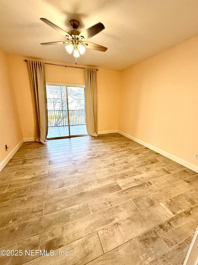 unfurnished room featuring a ceiling fan, baseboards, and wood finished floors