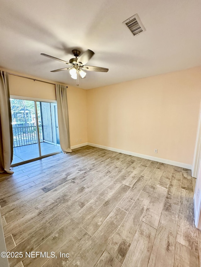 unfurnished room featuring light wood-style floors, ceiling fan, visible vents, and baseboards