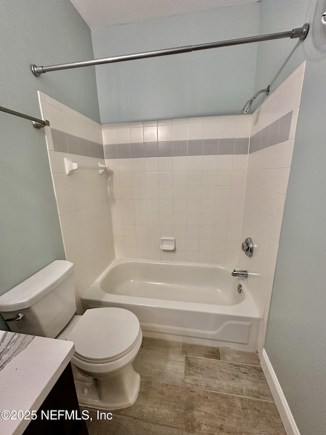 bathroom with toilet, washtub / shower combination, and vanity