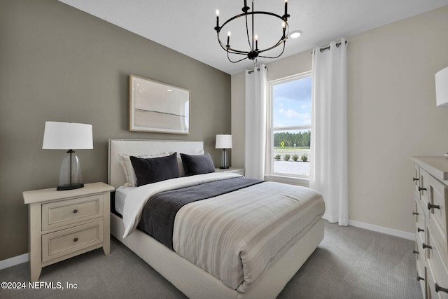 carpeted bedroom featuring a notable chandelier