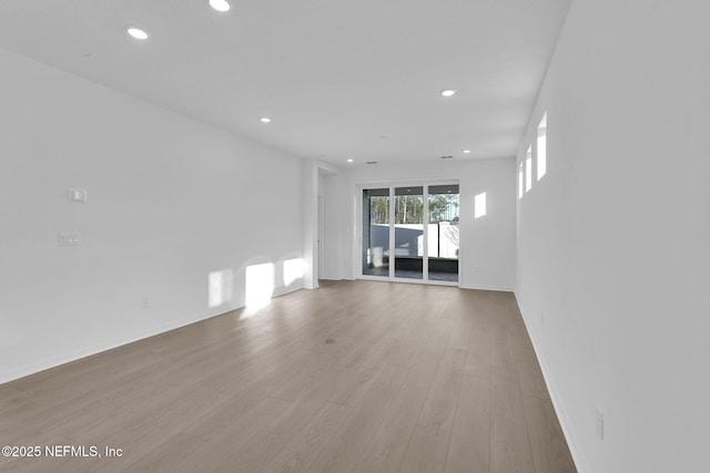 unfurnished living room featuring recessed lighting and wood finished floors