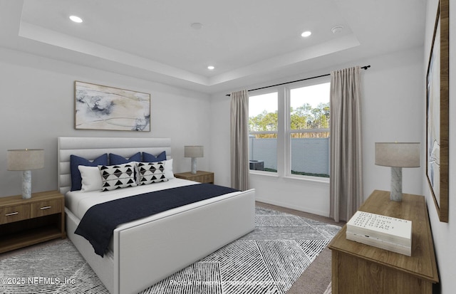 bedroom with recessed lighting, a raised ceiling, and baseboards