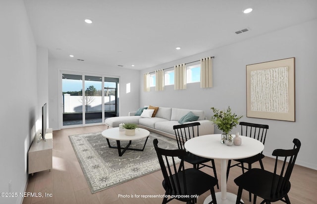 living room with visible vents, recessed lighting, and light wood-style floors