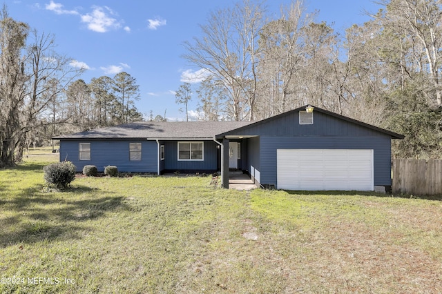 single story home featuring a garage and a front lawn