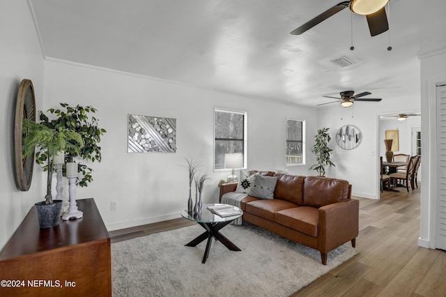 living room featuring ornamental molding and hardwood / wood-style flooring