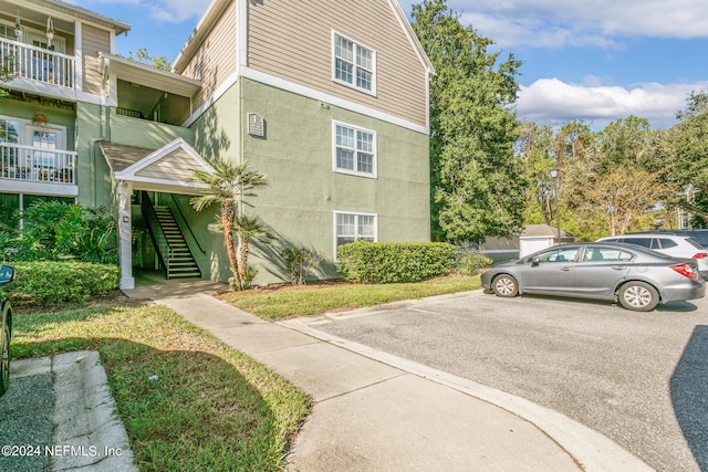 view of side of property with a balcony