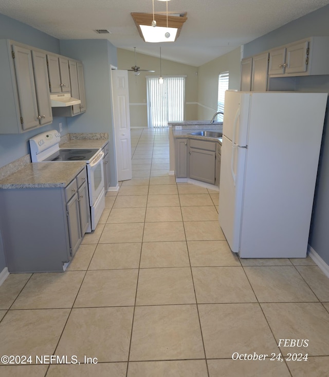 kitchen featuring lofted ceiling, gray cabinetry, sink, light tile patterned floors, and white appliances